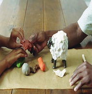 Two people making things out of playdough