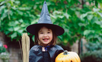 girl with witch hat and pumpkin